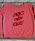 A pink sweatshirt with the words kindness and weakness on it.