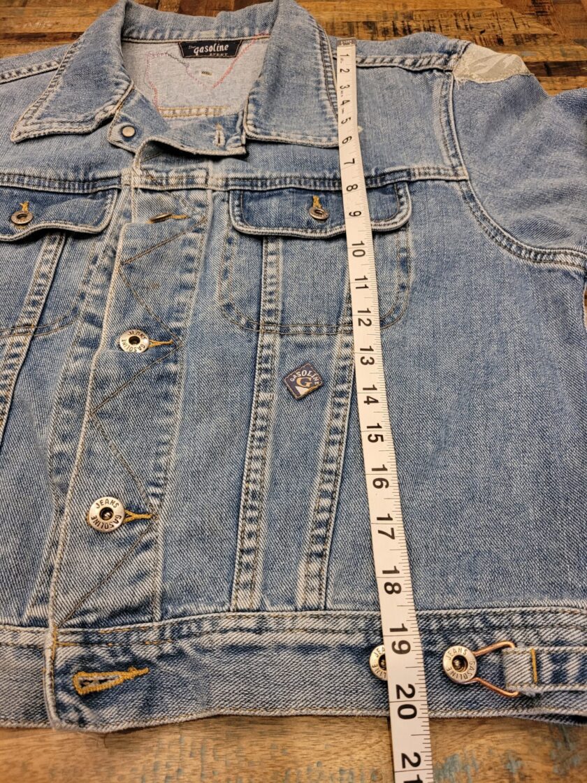 A denim jacket with a measuring tape on it.