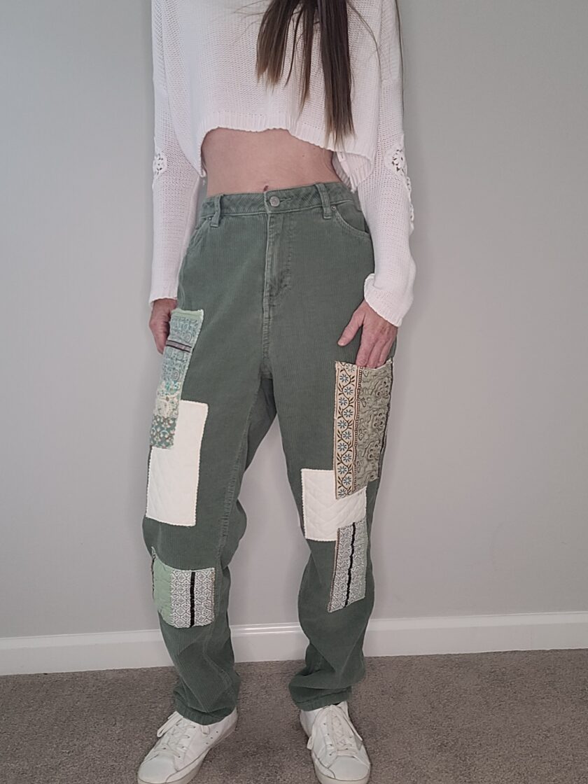 A woman wearing green patchwork pants.