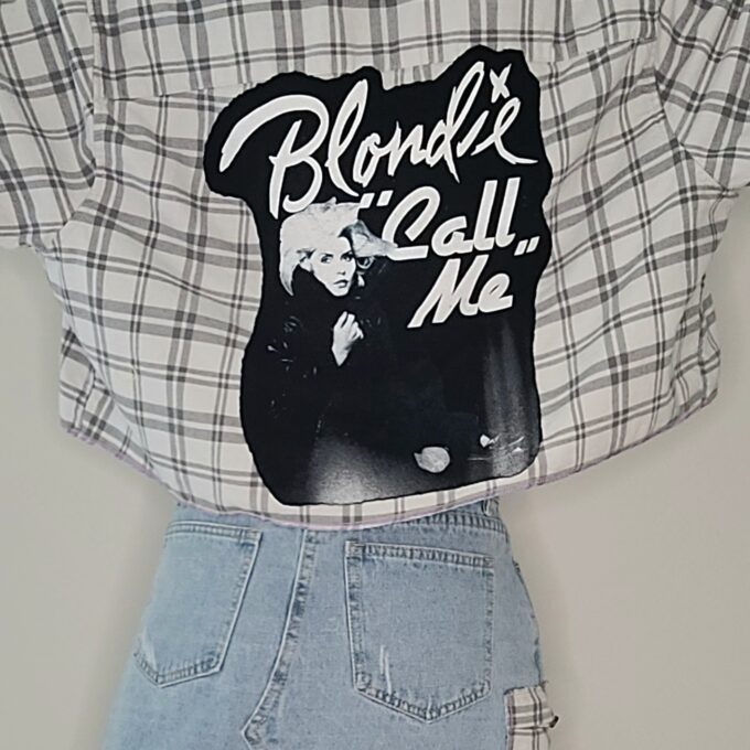 A shirt with a sticker that says blonde's call me.