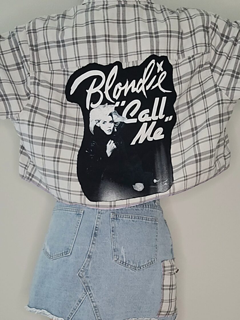 A shirt with a sticker that says blonde's call me.