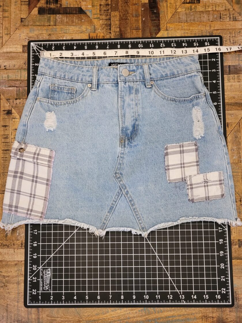 A denim skirt with patches on it.
