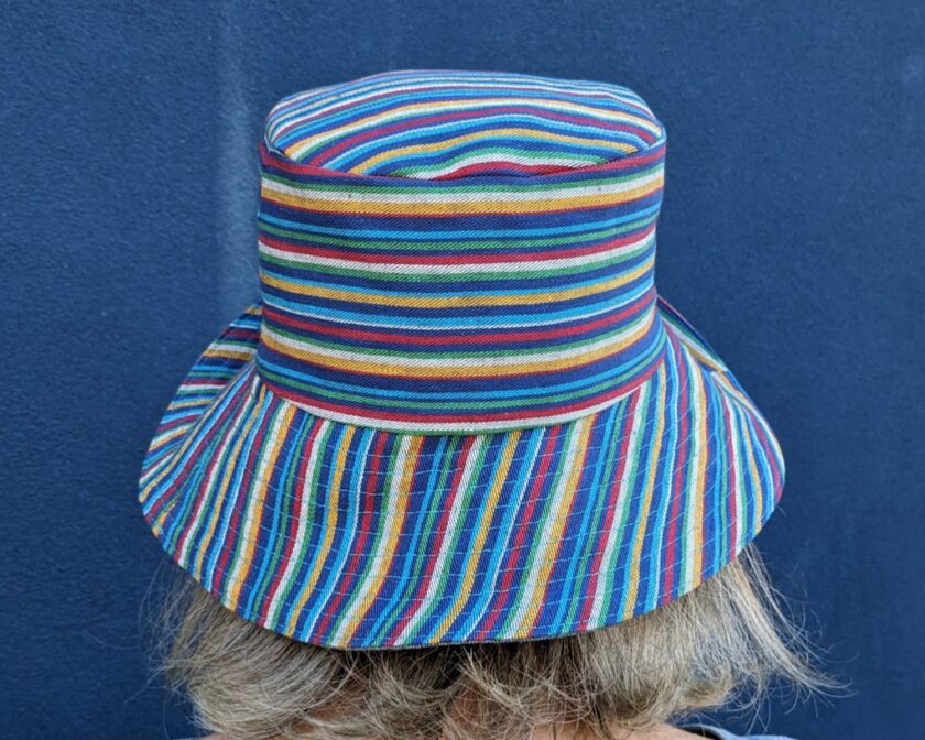 The back of a woman wearing a colorful striped hat.