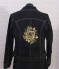A black denim jacket with gold roses on the back.
