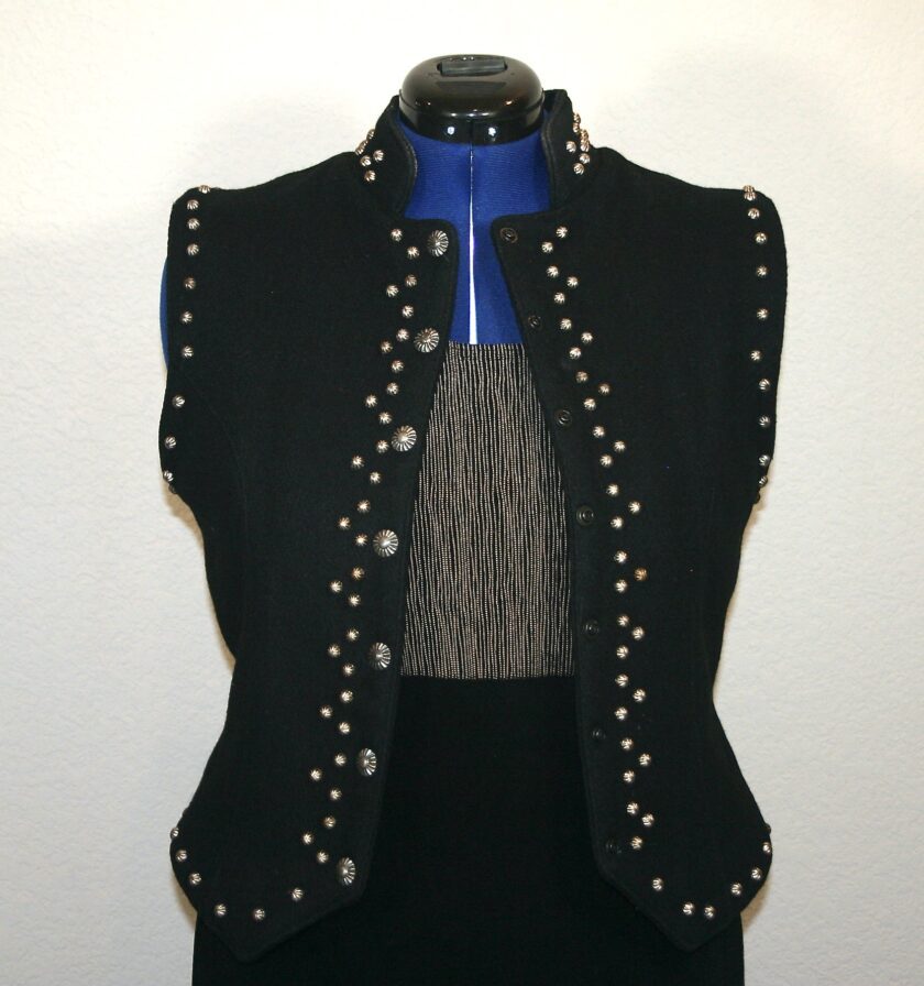 A black vest with studding on it.