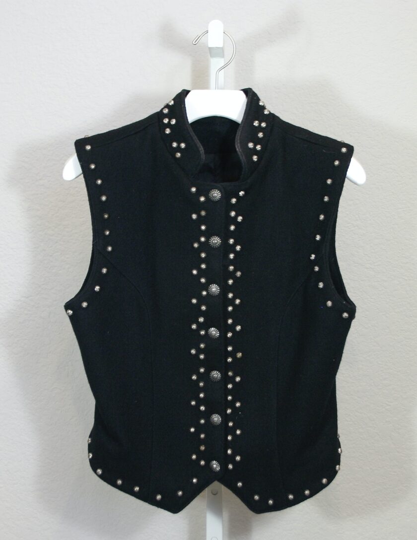 A black vest with studding on it.