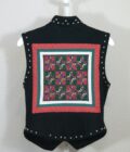 A black vest with a colorful quilted pattern.