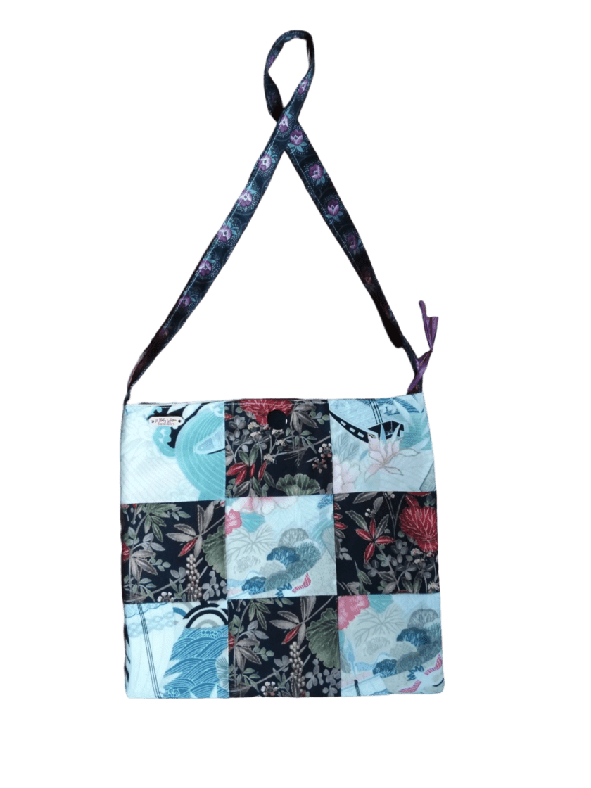 A handbag with a patchwork pattern and a strap.