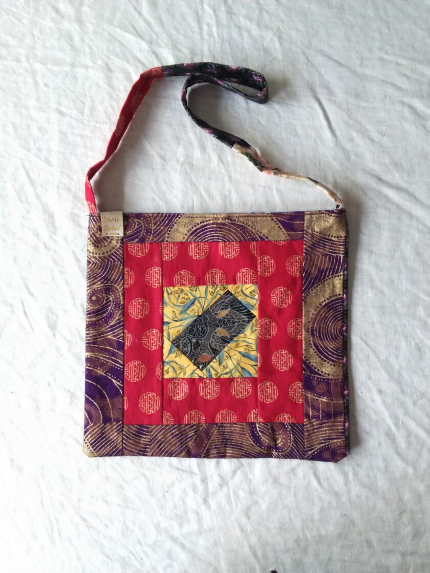 A red and yellow quilted bag