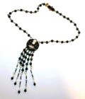 A black and white necklace with a beaded fringe.