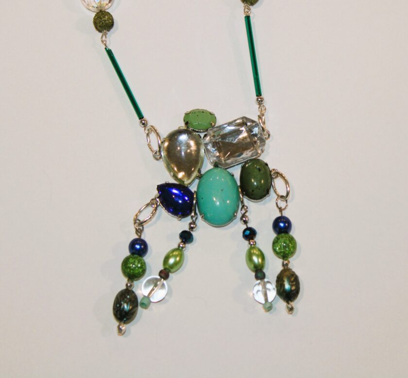 A necklace with green and blue beads.