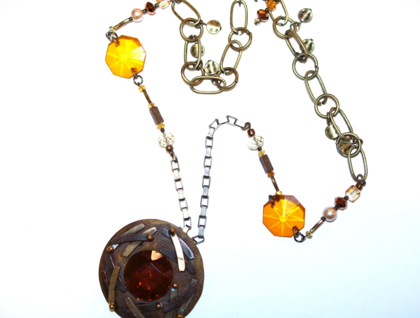 A necklace with a large pendant and a chain.