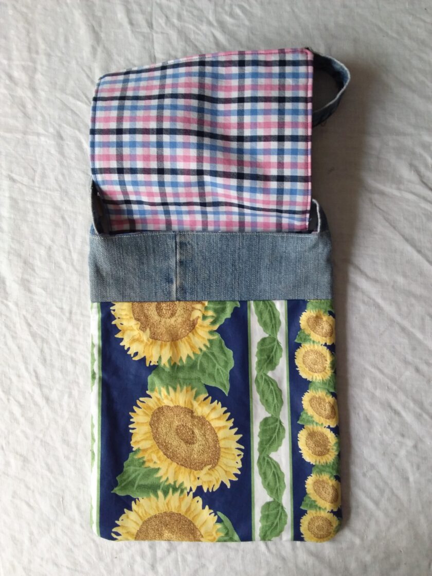A repurposed denim bag with sunflowers on it.