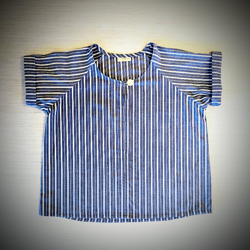 A blue and white striped shirt on a table.