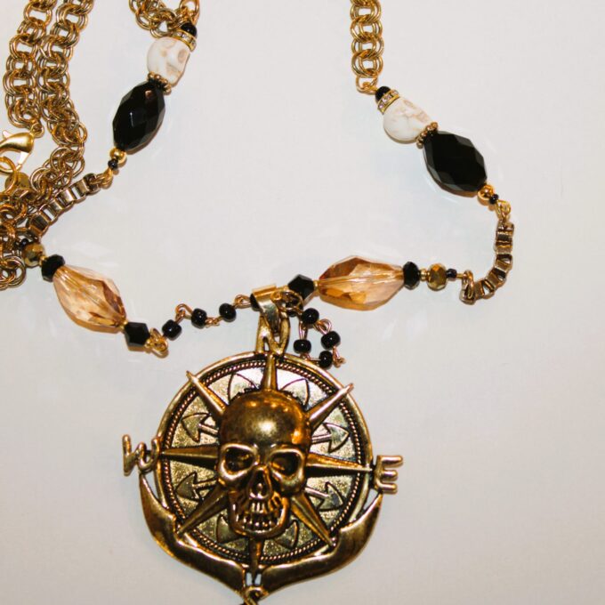 A necklace with a skull and compass on it.