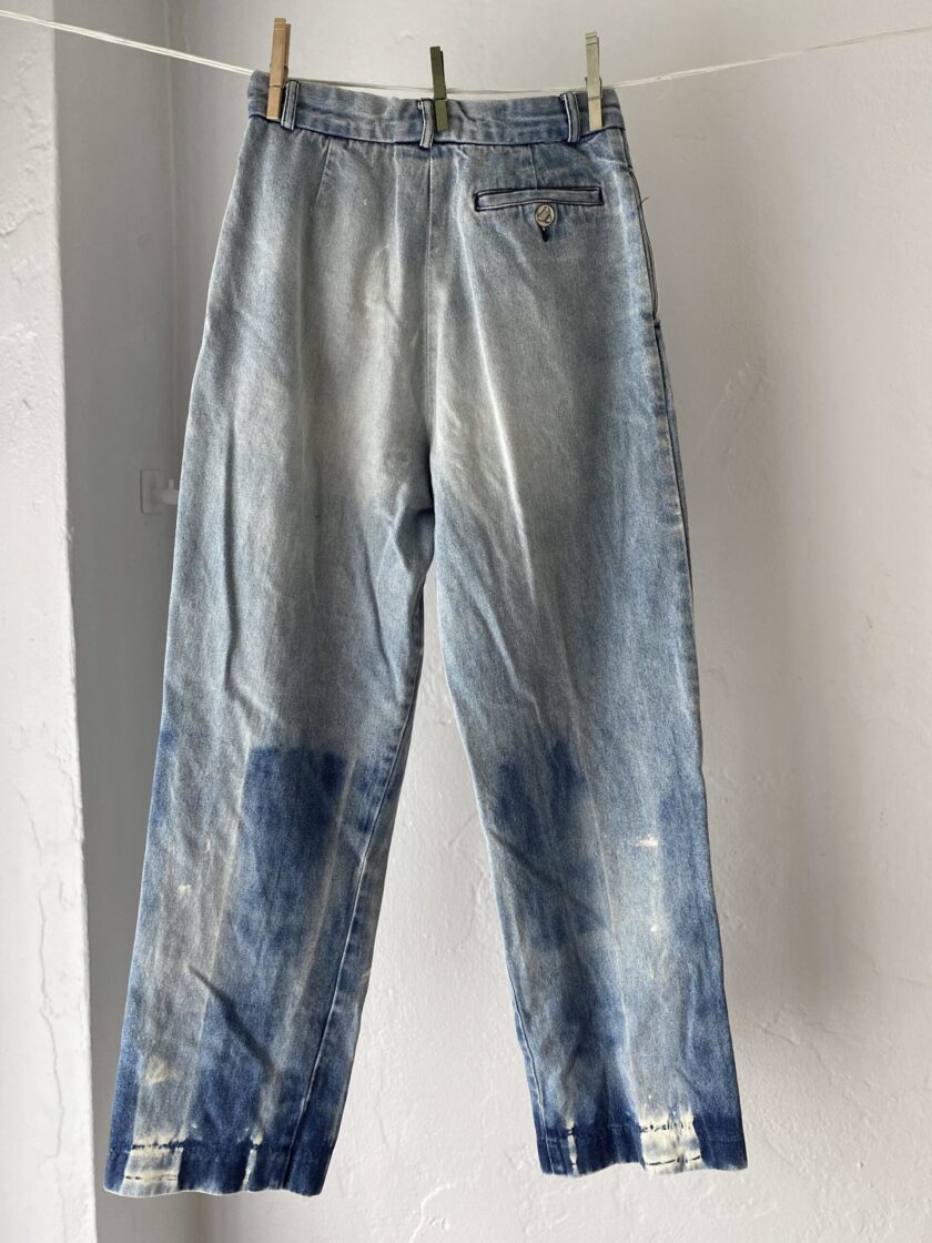 Back of bleached denim jeans hanging on clothes line.