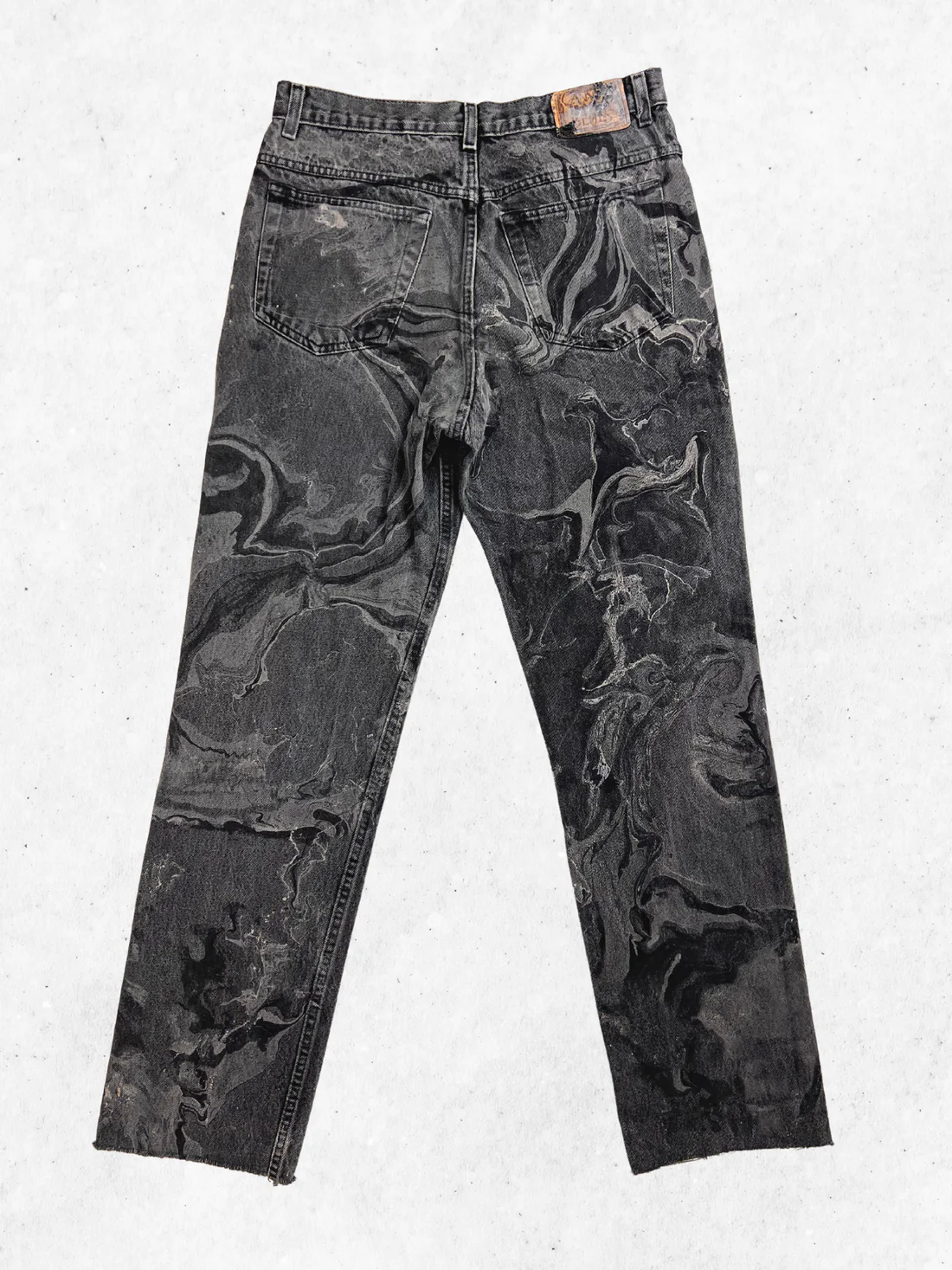 A pair of black and gray pants with a marble pattern.