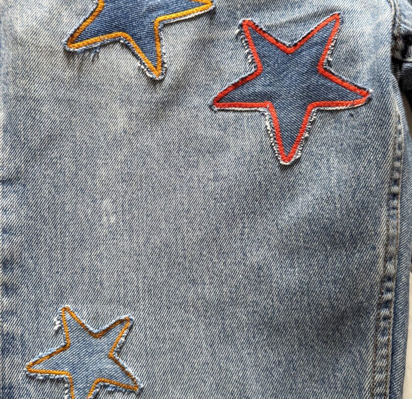 A denim jacket with stars embroidered on it.