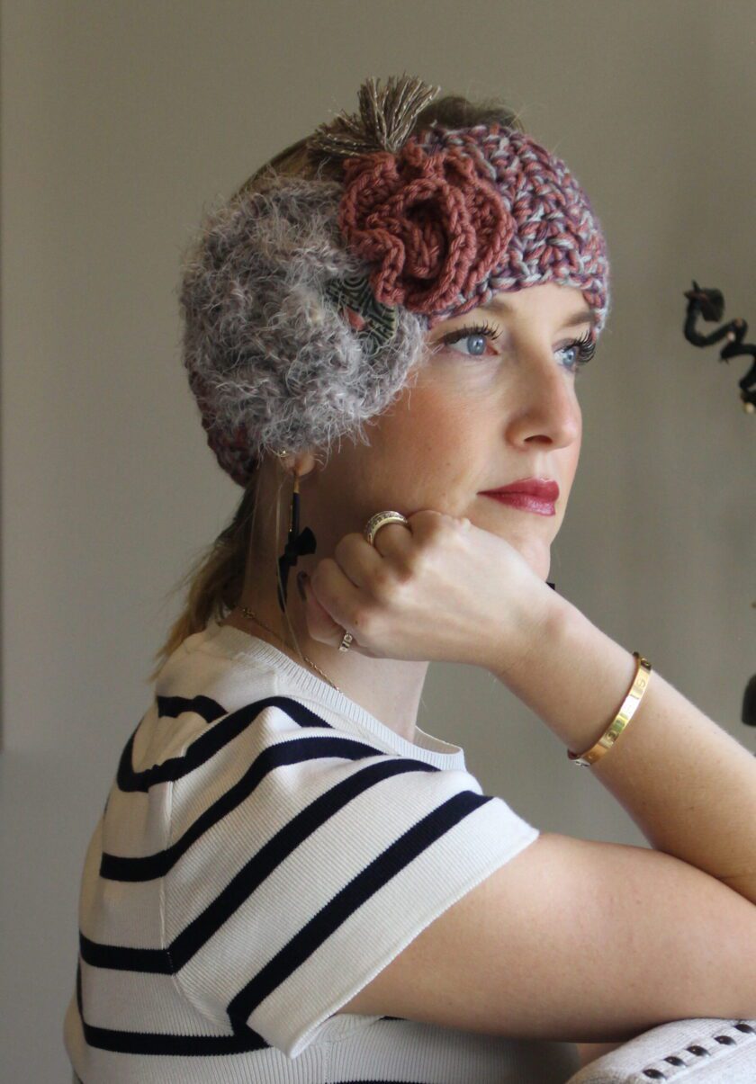 A woman wearing a crocheted headband.