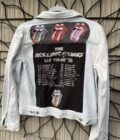 The rolling stones denim jacket hanging on a wall.
