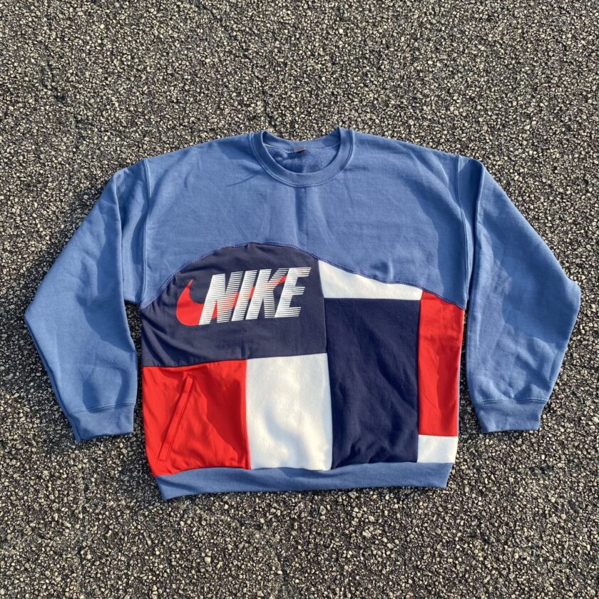 A nike sweatshirt with a red, white and blue design.