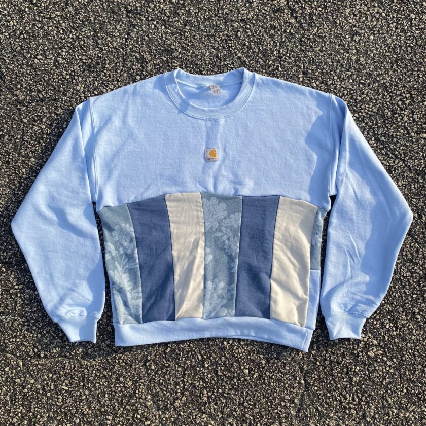 A light blue sweatshirt with a patch on it.