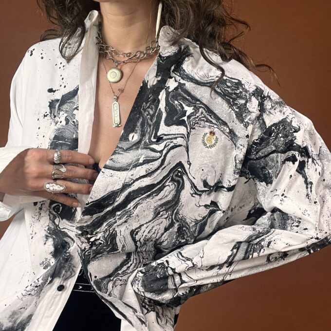 A woman wearing a white and black marble print shirt.