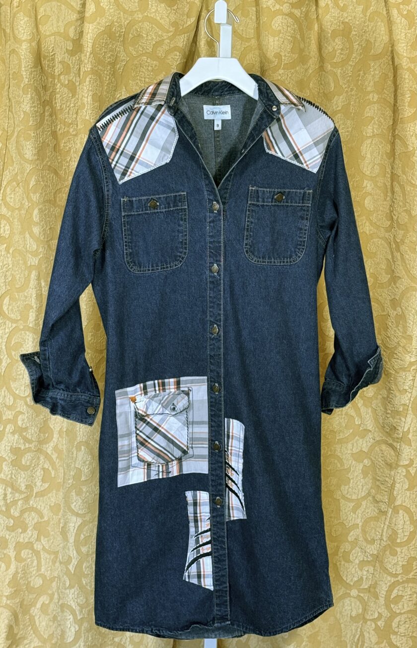 A denim shirt with patches on it.
