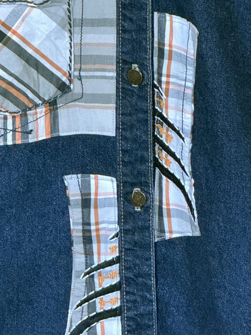 A blue denim shirt with a patch on it.