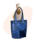 A blue denim tote bag on a mannequin.