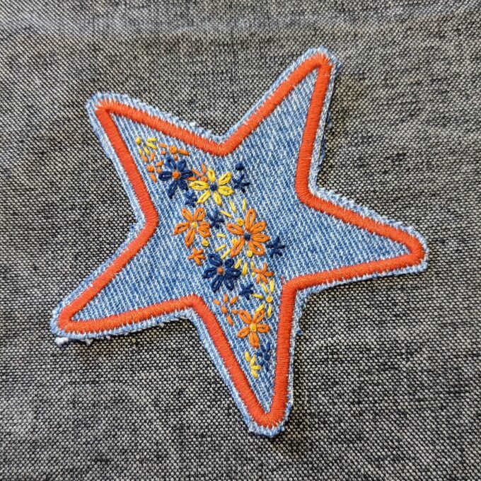 A star embroidered on a piece of denim.
