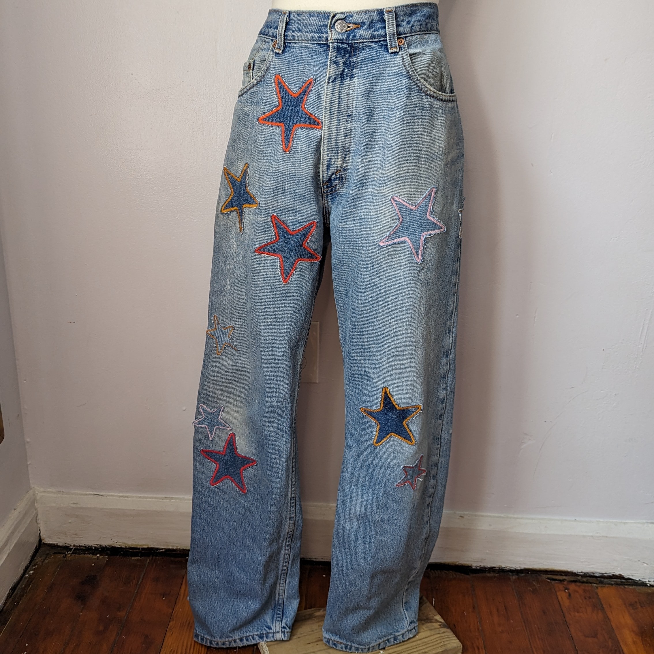 A mannequin wearing a pair of jeans with stars on them.