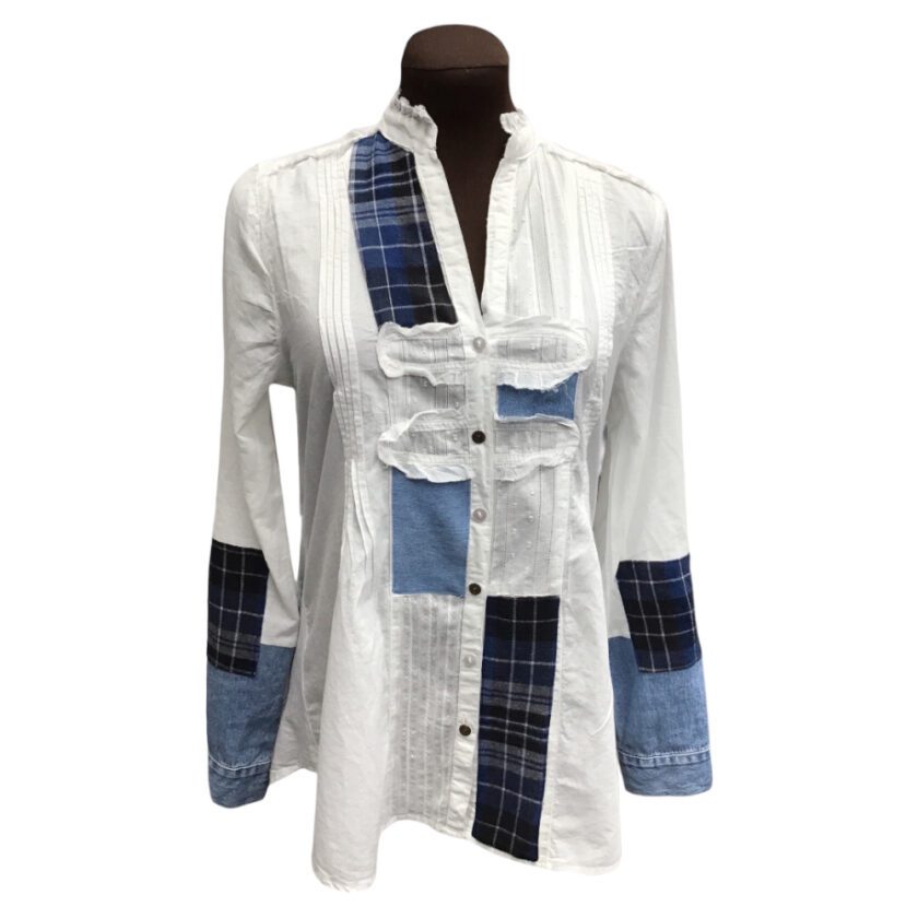 A white shirt with blue and white patches on it.