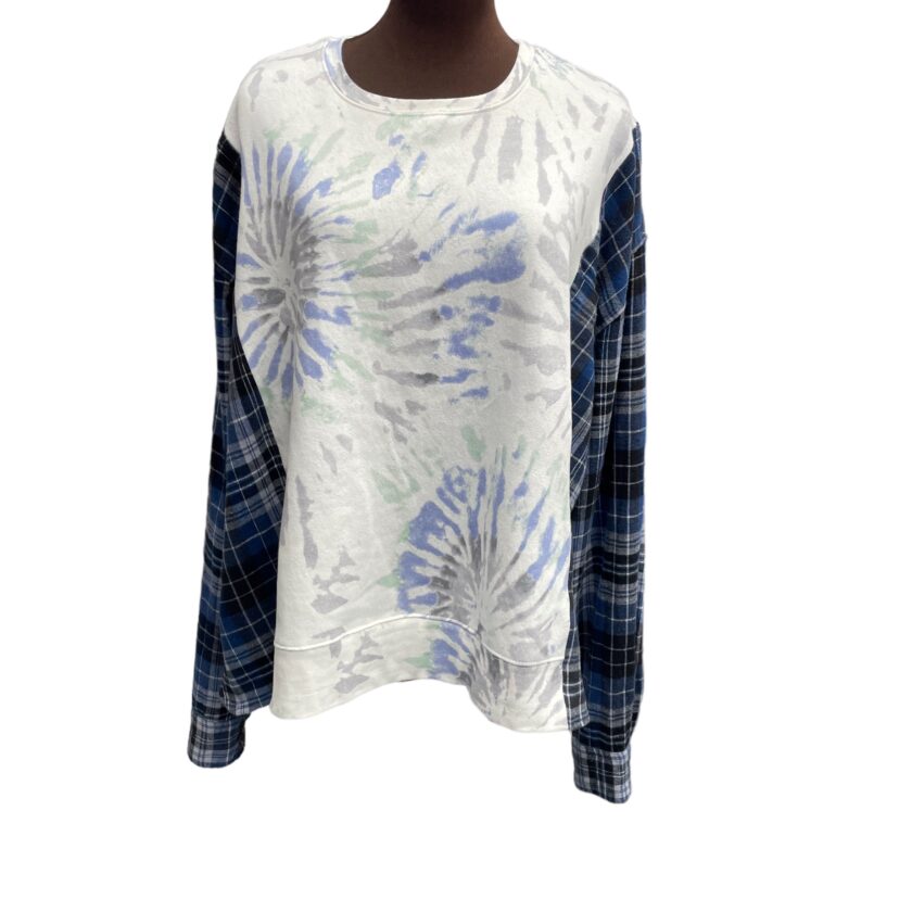A mannequin wearing a white and blue tie dye shirt.