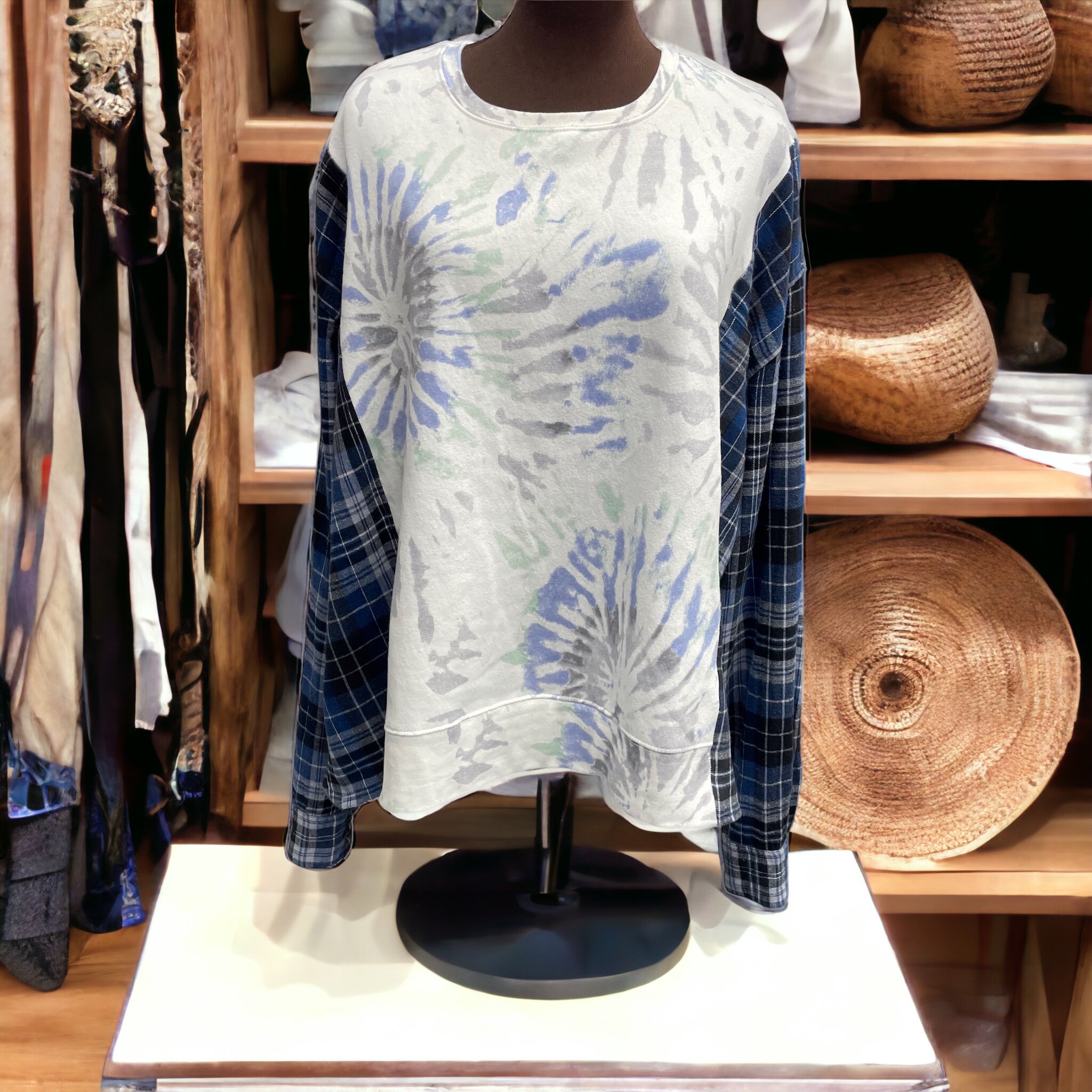 A mannequin displaying a tie dye shirt.