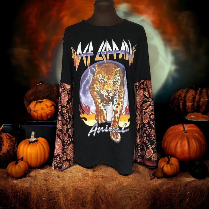 A black t - shirt with an image of a tiger and pumpkins.