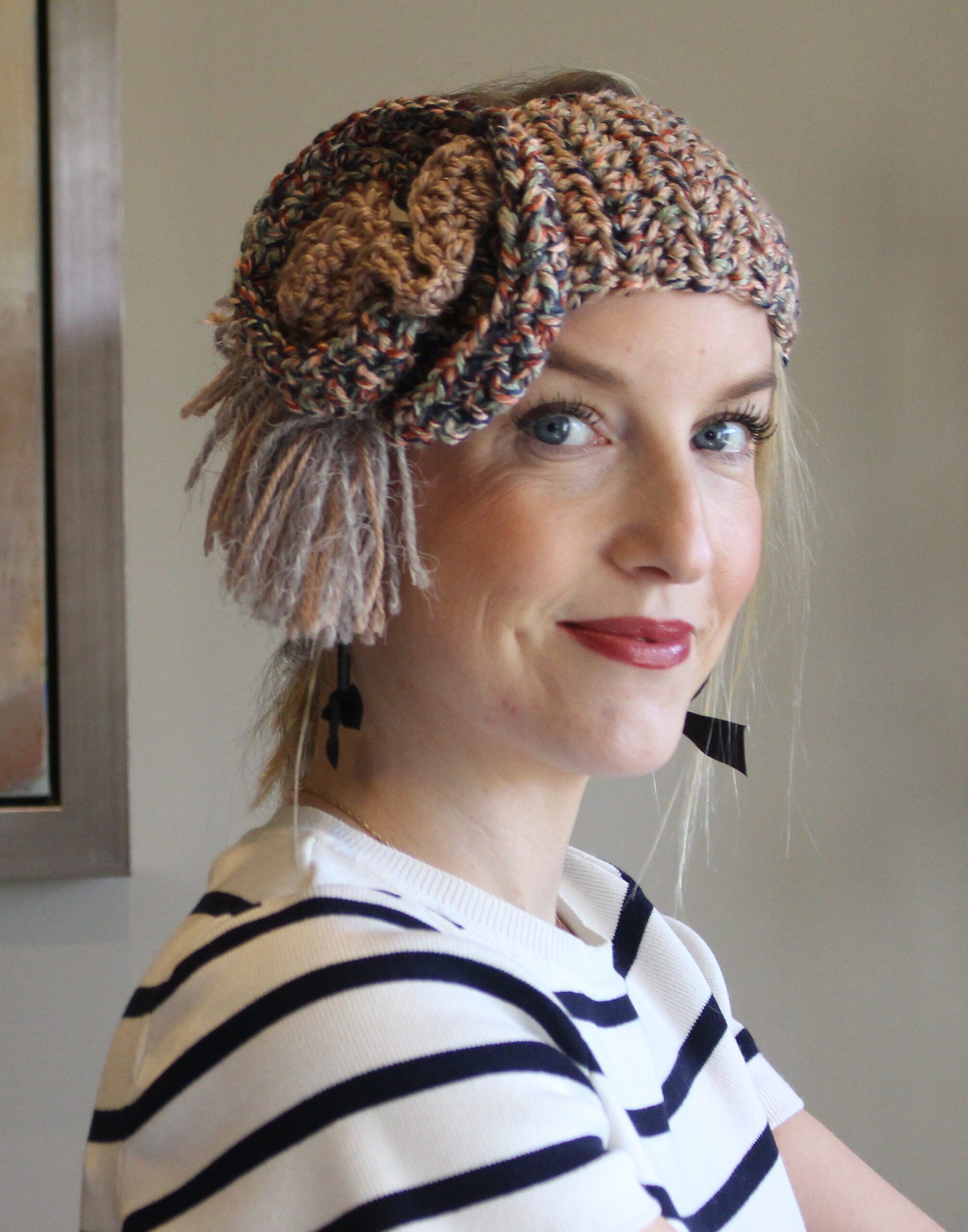 A woman wearing a crocheted flower headband.