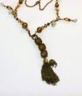 A necklace with a tassel and beads.