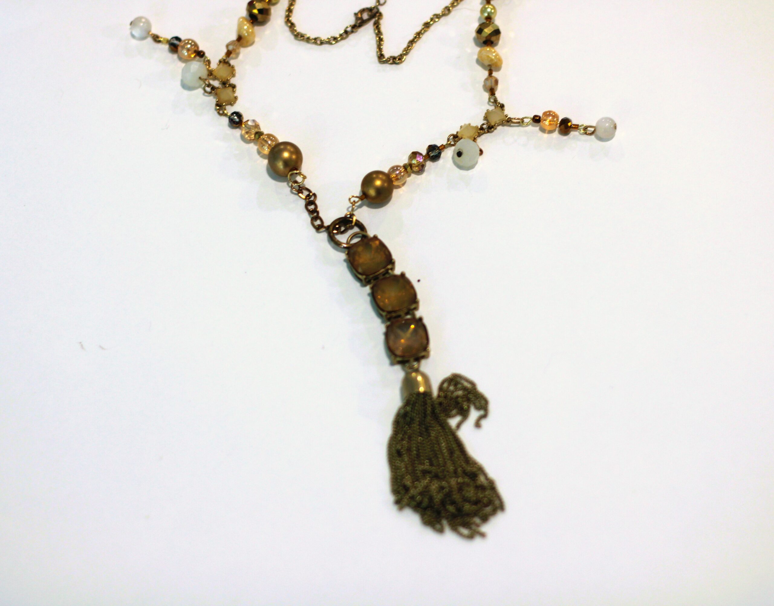 A necklace with a tassel and beads.