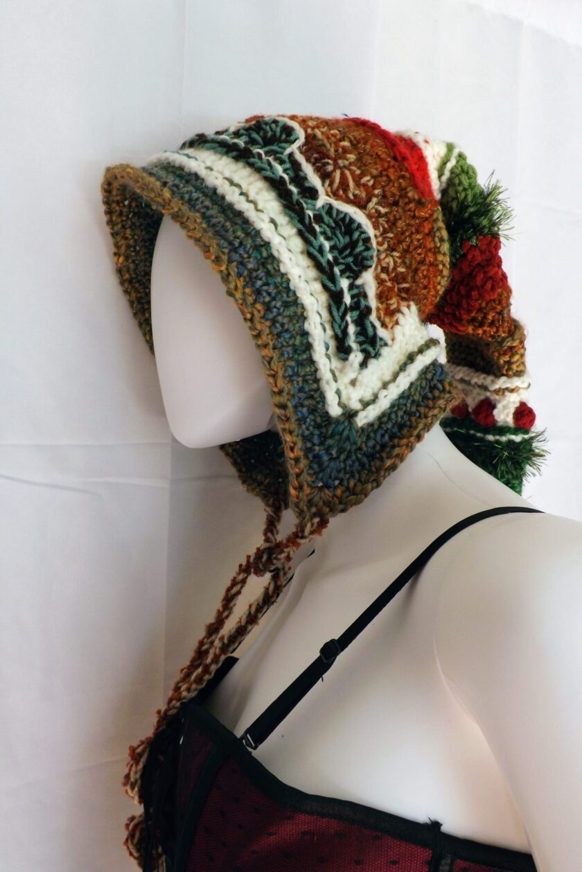 A crochet stocking cap done in elf hood style with earth toned yarns
