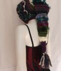 A long crochet elf hood in shades of purple and teal.