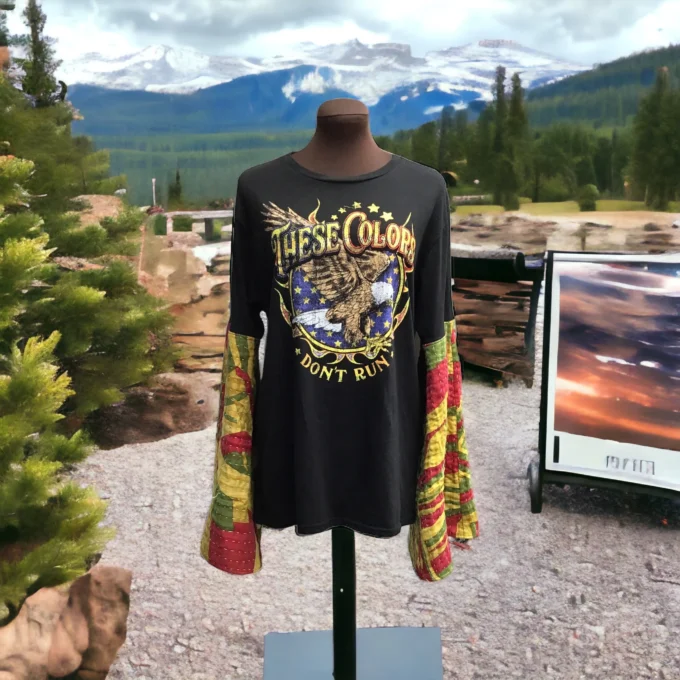 A t - shirt on display with mountains in the background.