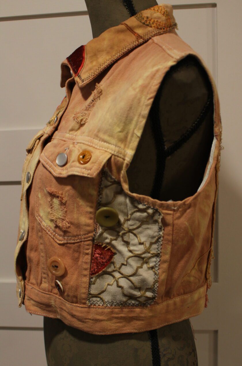 A mannequin mannequin wearing a denim vest.