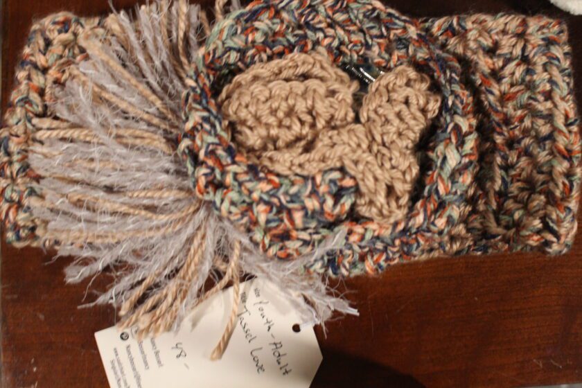 A crocheted headband with a tag on it.