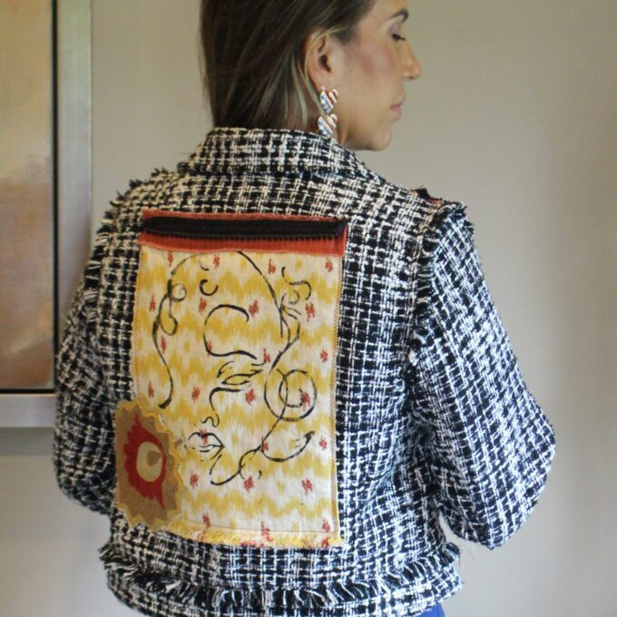 The back of a woman wearing a tweed jacket.
