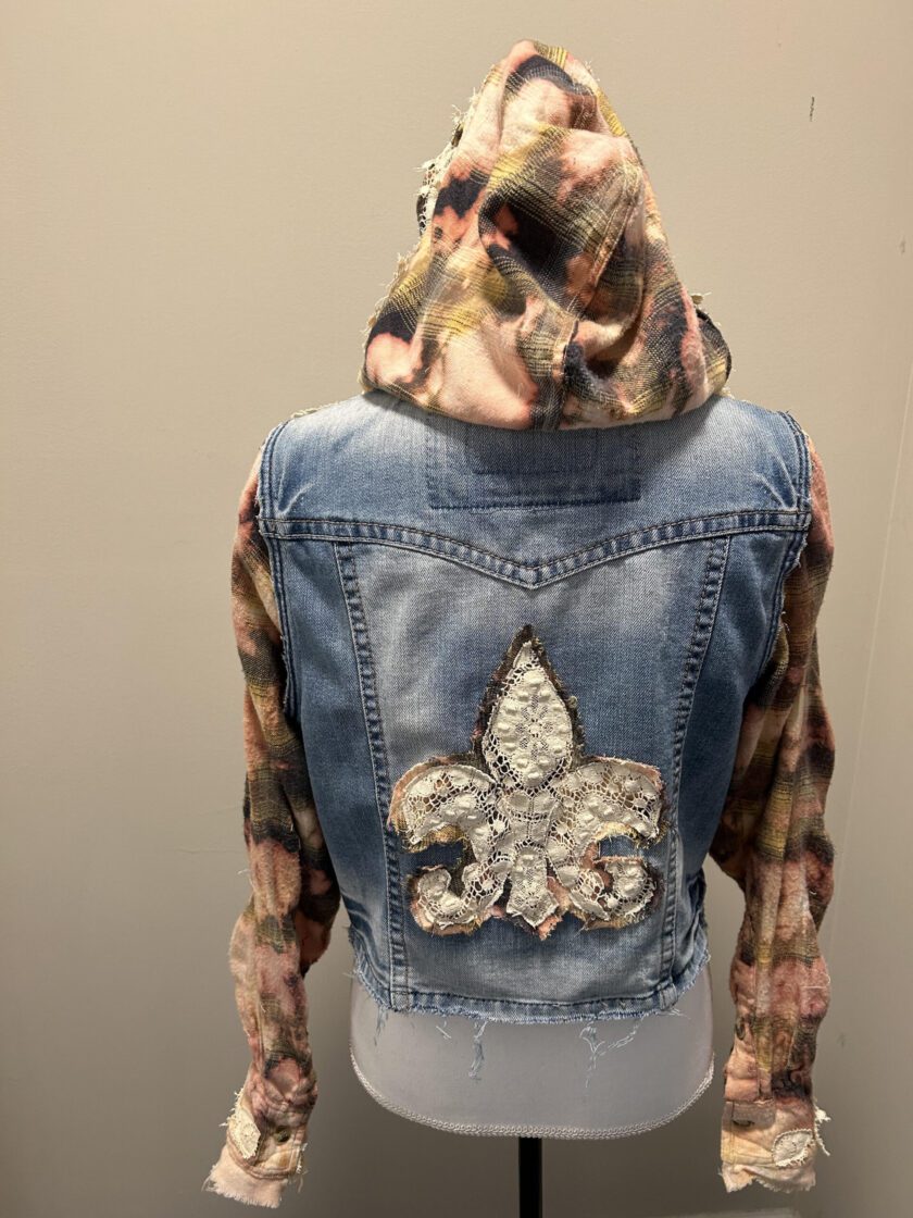 A denim jacket with a floral hoodie.