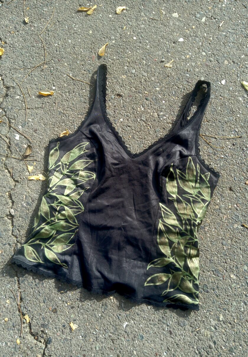 A black tank top laying on the ground.