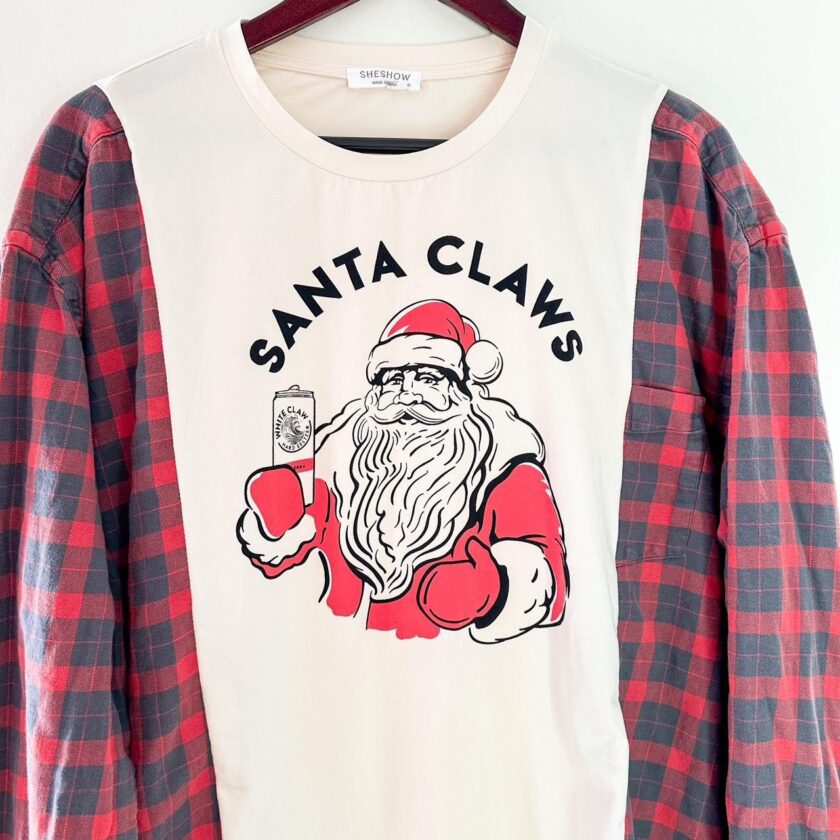 A santa claws t - shirt hanging on a hanger.