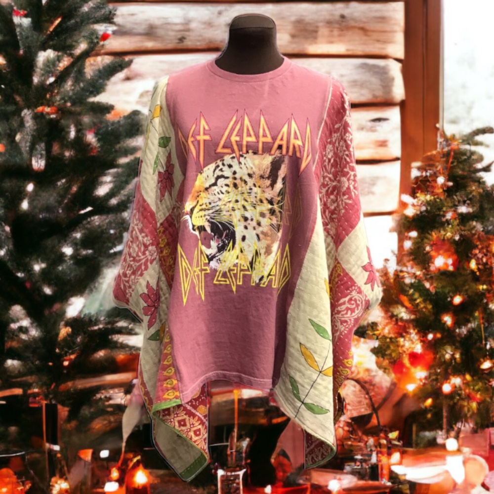 A pink t - shirt with an image of a tiger next to a christmas tree.