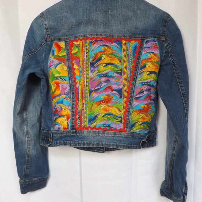 A thrifted denim jacket with Laurel Burch horse fabric and red trim.